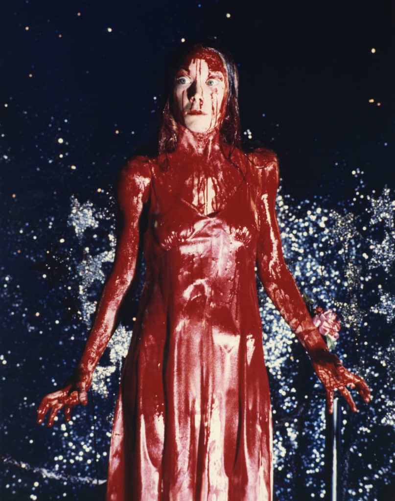 Carrie covered in blood left, carrie hugging her mother on right