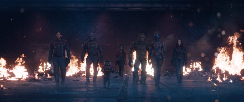 The Guardians of the Galaxy walk away from an explosion.