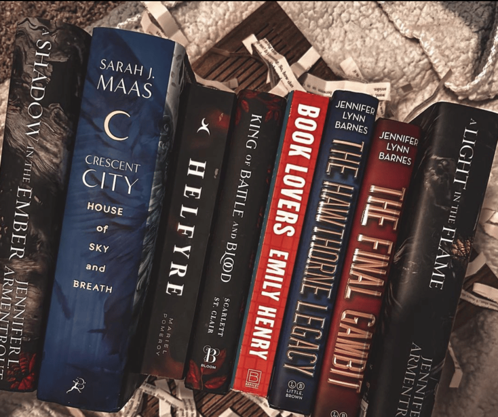 A row of books are displayed, with subtle decorative elements in the background.