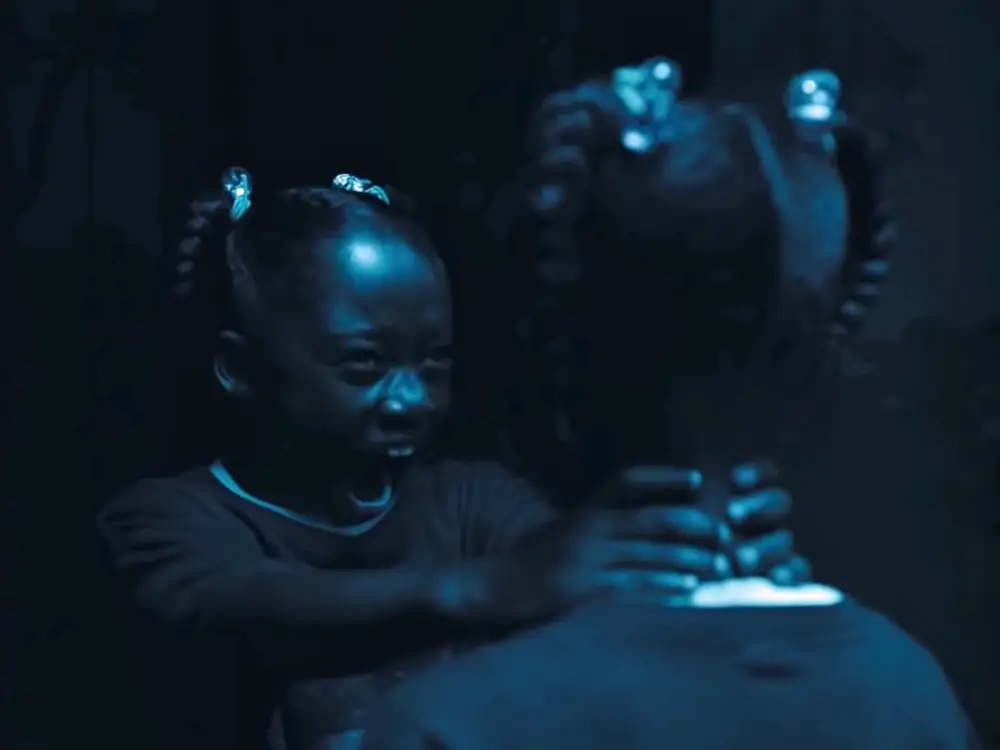 one girl is choking the other, the two girls exactly the same