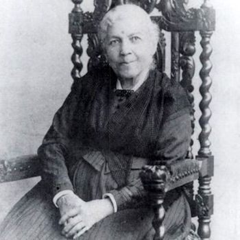 Harriet Jacobs posing in a chair for a photo.