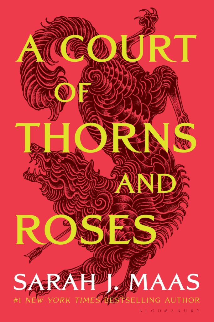The cover for 'A Court of Thorns and Roses' depicting a beast behind the text.