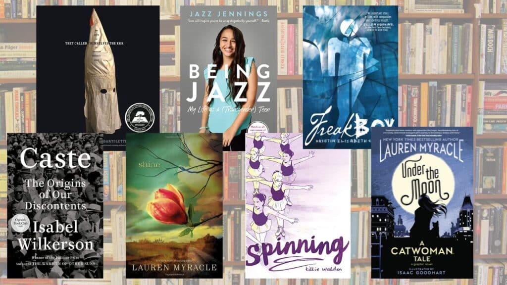 A collection of books recently retured to local Llano County, Texas library due to unconsitutional book ban. Book covers from left to right.They Called Themselves the KKK by Susan Campbell Bartolletti, Being Jazz by Jazz Jennings, Freakboy by Kristin Elizabeth Clark, Caste by Isabel Wilkerson, Shine by Lauren Myracle, Spinning by Tillie Walden, Under the Moon by Lauren Myracle.