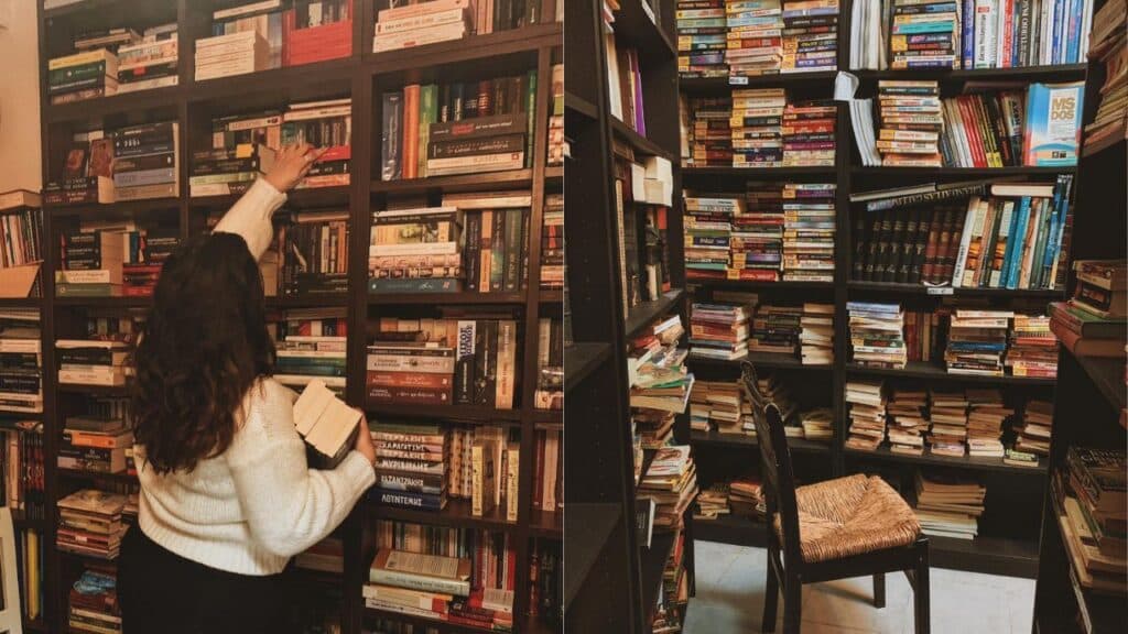 Two images side by side.On the left, our Bookstagrammer of the Week, Matina of @breathing_pages, is shopping in a completely full bookstore. She is wearing a light colored long sleeve shirt and is already holding a stack of books. She is reaching upwards for another book on a higher shelf. On the right is a picture of completely full bookshelves. There is one lone chair sitting in front of the shelves. cr. Matina / @breathing_pages