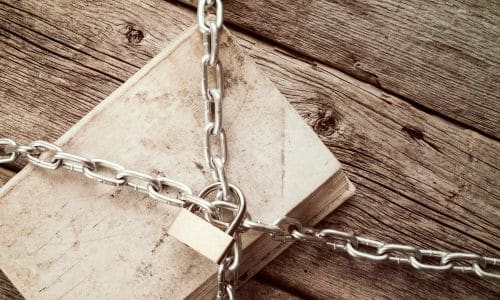 book-locked-under-chains-on-wood-planks-book-banning-press-suppression