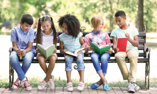 kids-reading-on-a-bench-book-banning-press-suppression