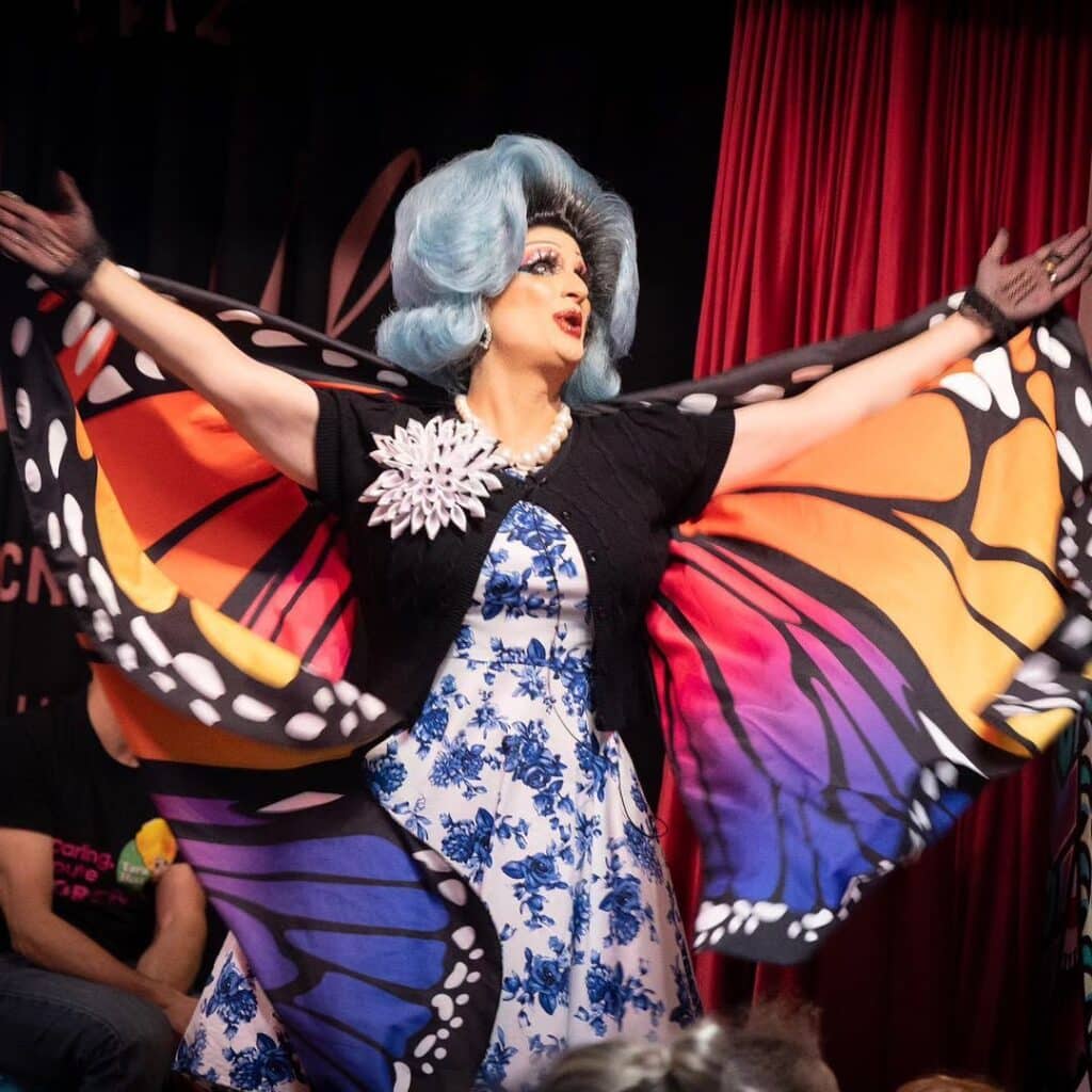 Drag queen performing in butterfly outfit