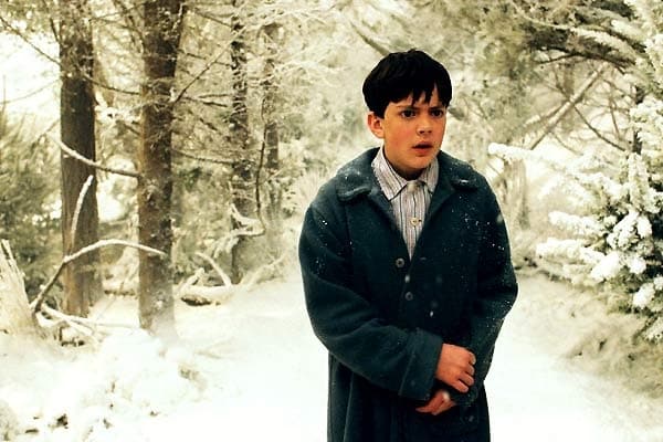 edmund-pevensie-walks-through-a-snow-covered-forest-ya-fantasy