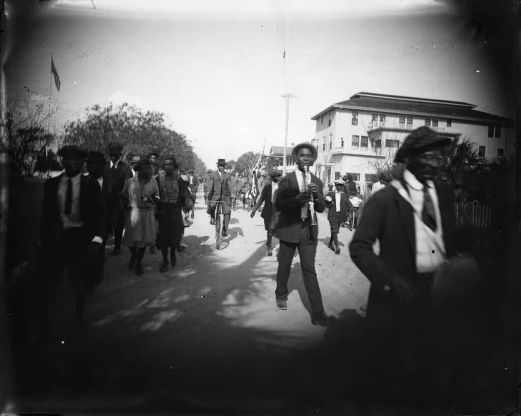 black-and-white-image-of-people-walking-through-the-street-emancipation-juneteenth-anti-slavery