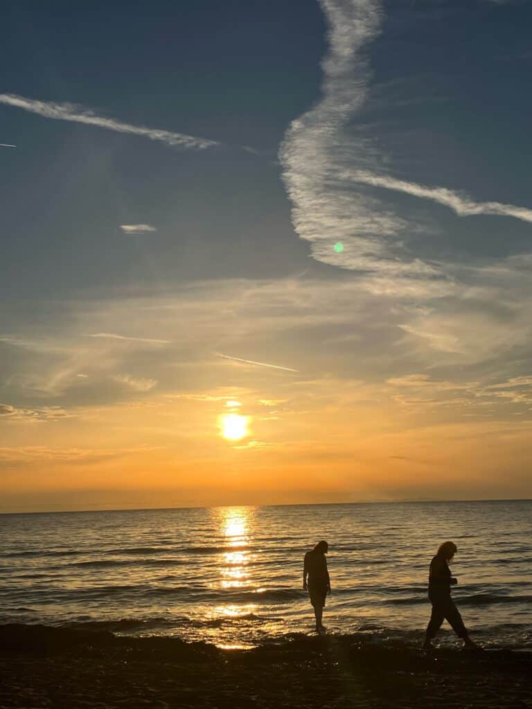 two-people-walking-along-the-shore-line-looking-for-shells-and-the-sun-is-setting-poetry-poems-ocean