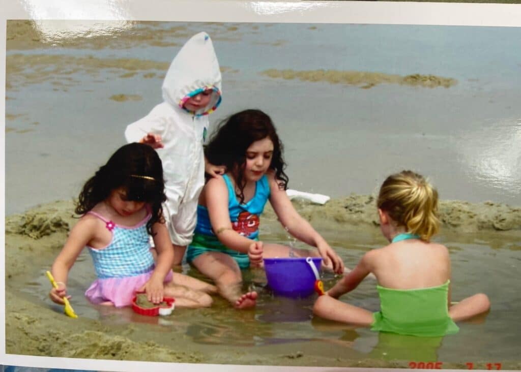 four-young-girls-sitting-and-playing-in-the-sand-ocean-poetry-poem