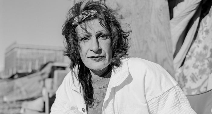 stonewall-great-leaders-black-and-white-photo-of-sylvia-rivera-outside-near-tents-trans-gay