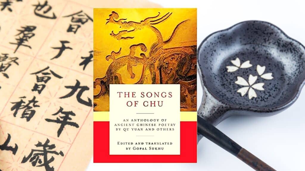 background-of-a-brush-holder-and-mandarin-text-on-a-piece-of-paper-with-a-book-cover-large-golden-dragon-similar-to-the-dragon-boats-with-a-cut-separating-the-yellow-and-red-parts-the-songs-of-chu-an-anthology-of-ancient-chinese-poetry-by-qu-yuan-and-others-edited-and-translated-by-gopal-sukhu.