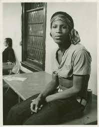 stonewall-great-leaders-black-and-white-photo-of-zazu-nova-sitting-at-a-table-trans-gay