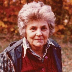 Portrait-of-Elizabeth-Bishop-old-woman-with-short-white-hair-outside-with-fall-foliage-in-background