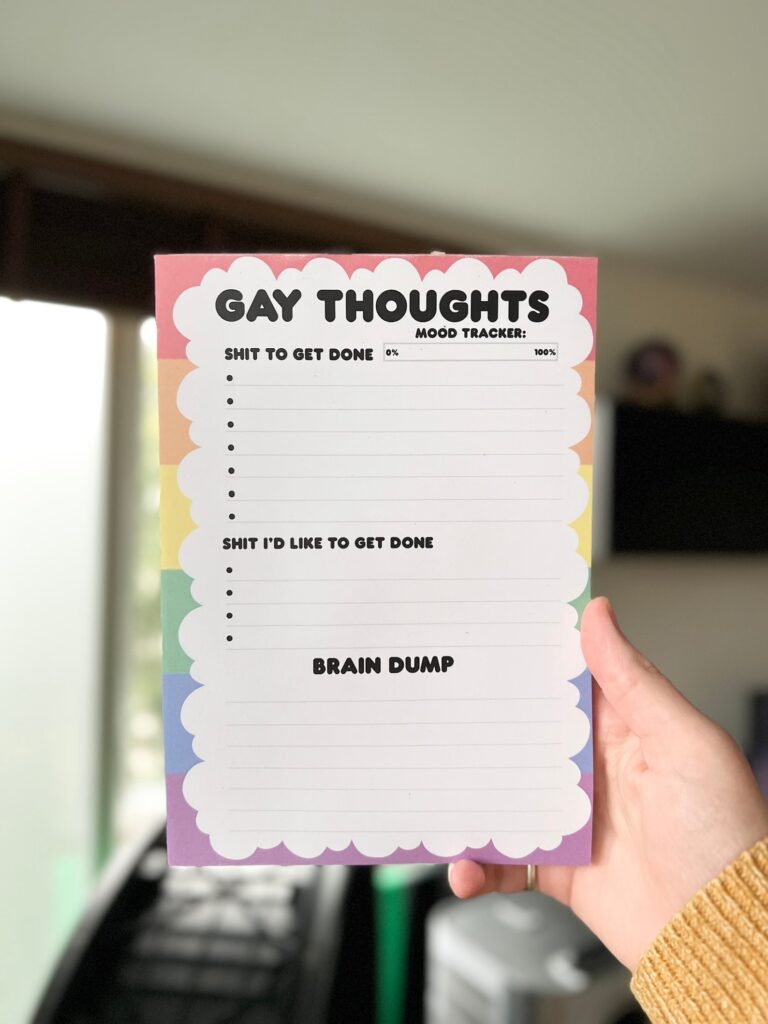 5-inexpensive-gifts-to-surprise-your-favorite-queer-writer-gay-thoughts-notebook-with-cloud-overtop-of-a-small-rainbow-background
