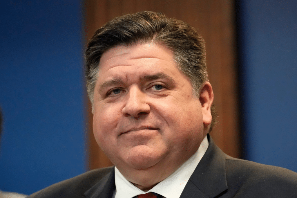 a-white-man-in-a-suit-in-front-of-a-blue-backdrop