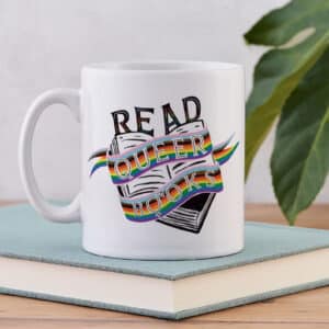 10-tempting-gifts-queer-book-nerds-will-love-white-mug-with-black-book-and-rainbow-highlighted-text-sitting-on-top-of-a-book
