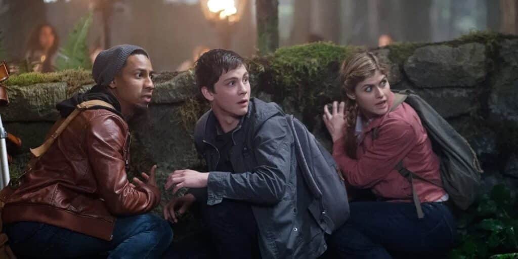 three-teens-hide-together-behind-rock-wall-grover-friends-percy-jackson