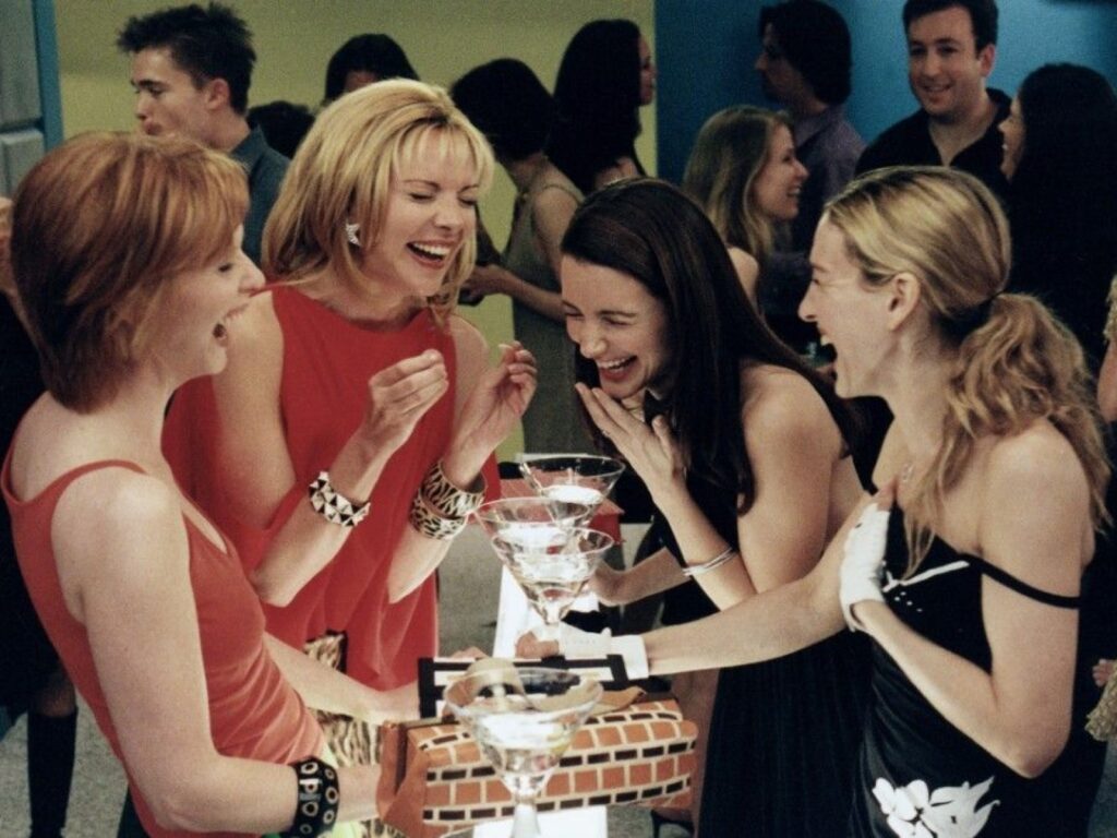 tv-show-from left to right-cynthia-nixon-as-miranda-hobbes-and-kim-cattrall-as-samantha-jones-kristin-davis-as-charlotte-york-sarah-jessica-parker-as-carrie-bradshaw-laughing-over-drinks
